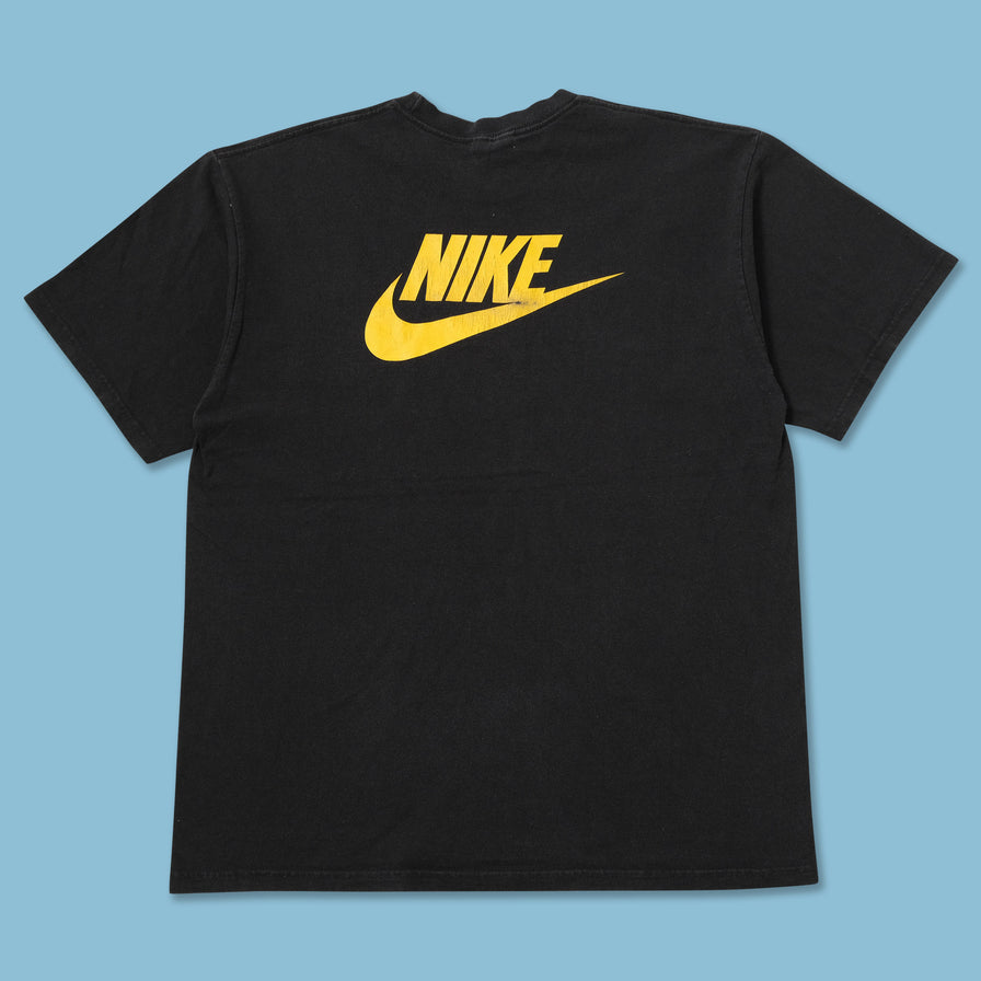 black nike shirt with yellow swoosh